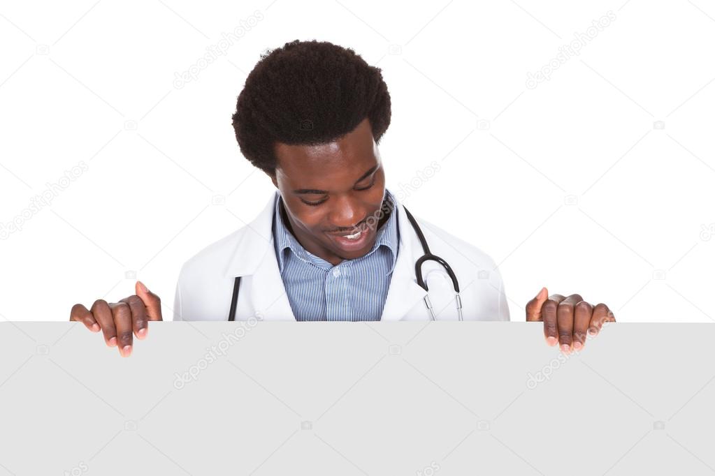 Male Doctor Standing With Placard