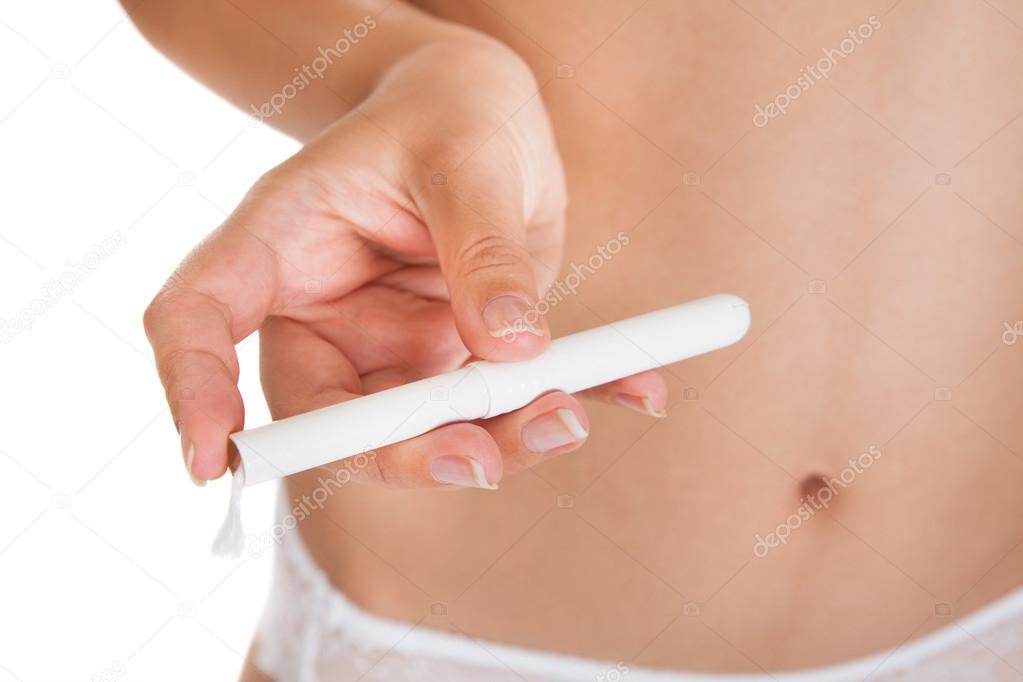 Close-up of hand holding tampon