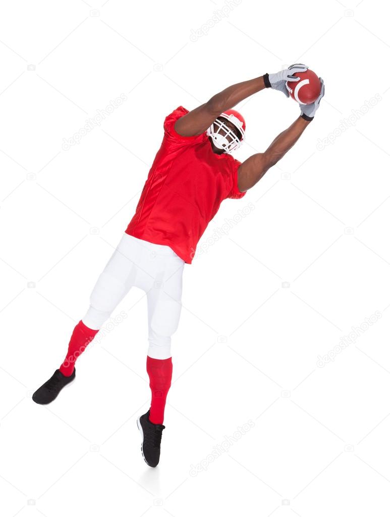 American Football Player Catching Rugby Ball