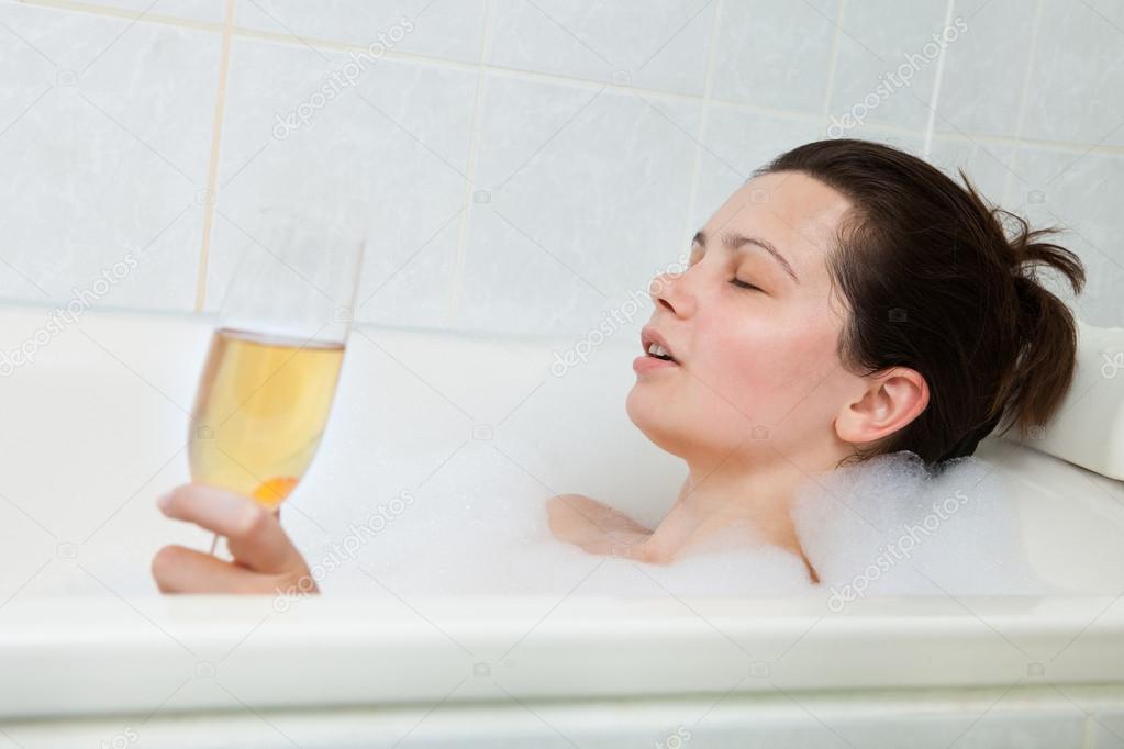Woman in bathtub drinking champagne Stock Photo by ©AndreyPopov 30728367