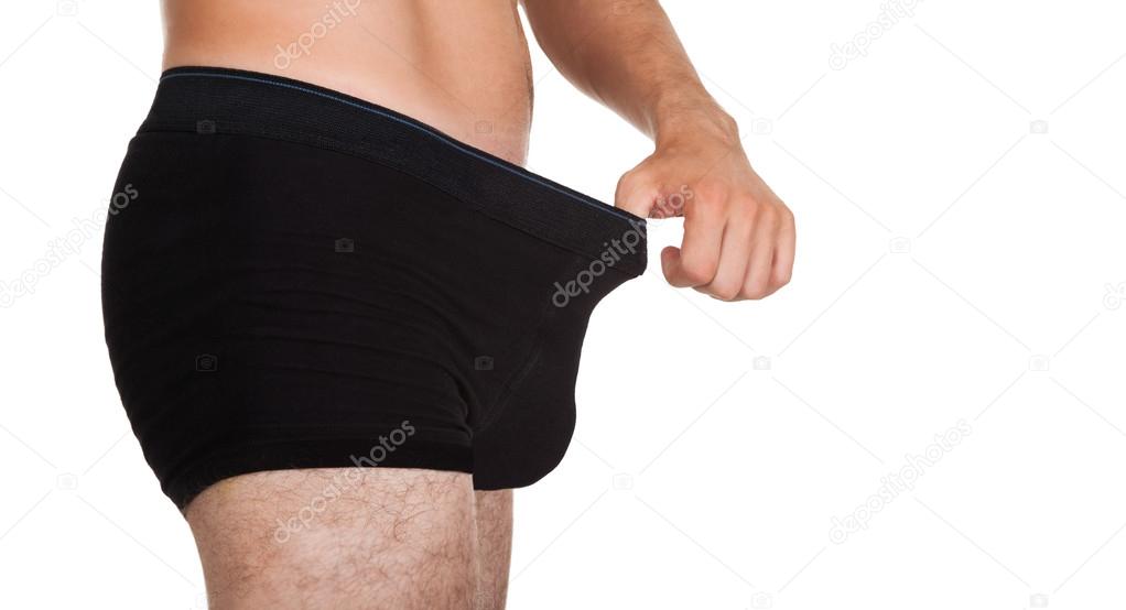 Man looking in his underwear Stock Photo by ©AndreyPopov 30728487
