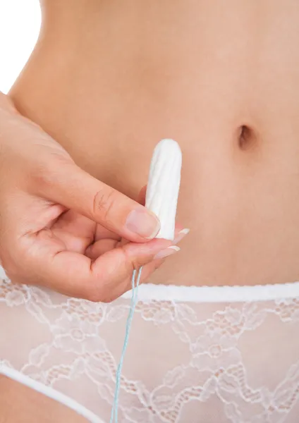 Close-up van hand hebt tampon — Stockfoto