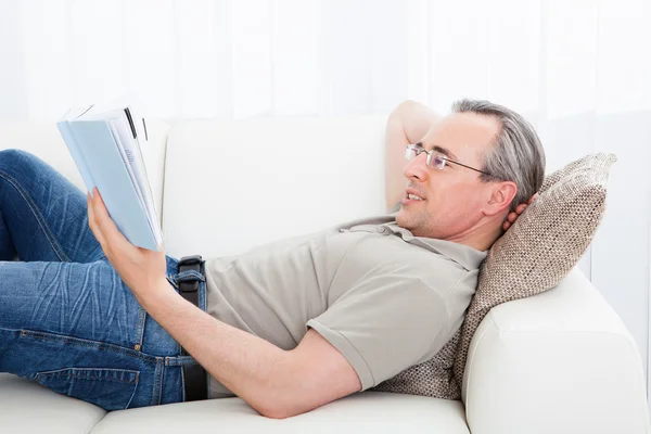 Reifer Mann liest ein Buch — Stockfoto