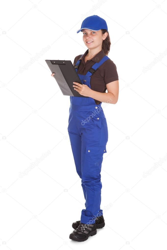 Female plumber holding clipboard