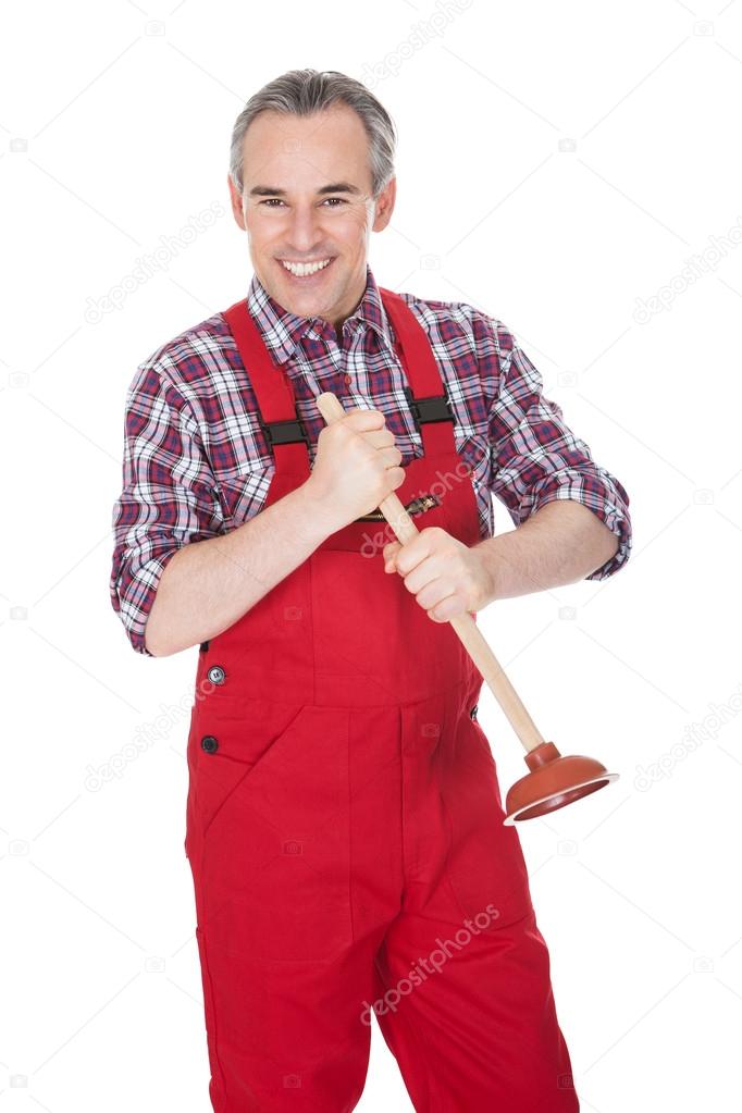 Portrait Of Male Plumber Holding Plunger