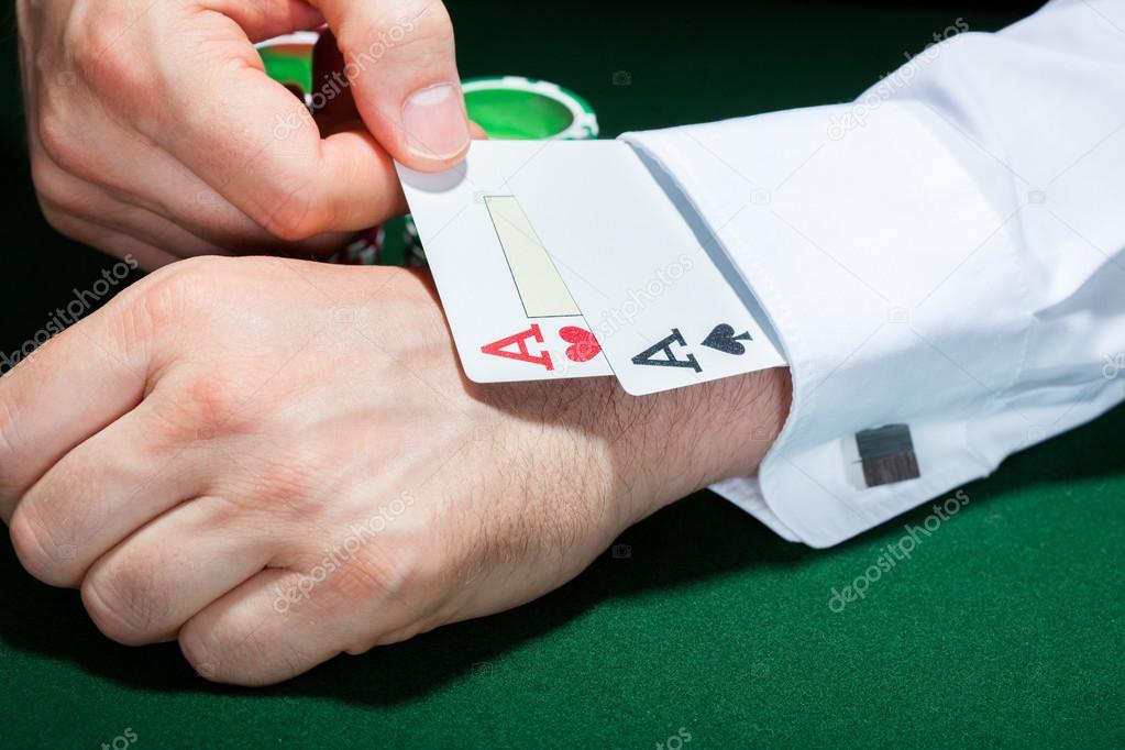 Human hand with playing cards in sleeve