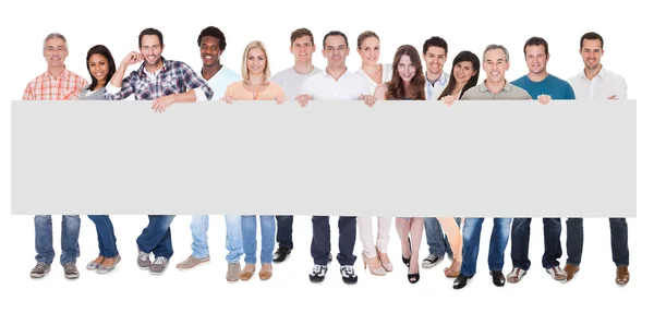 Group of business people with a blank banner — Stock Photo, Image