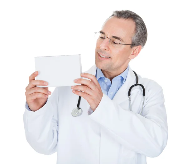 Doctor holding prescription note — Stok fotoğraf