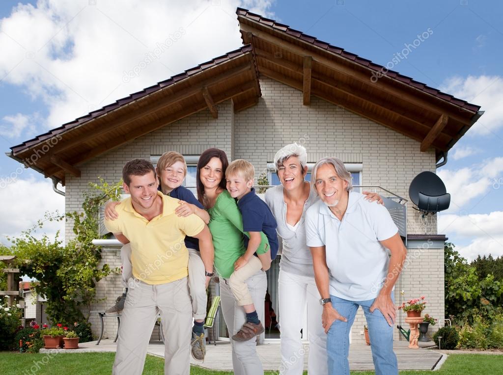 Multi-generation Family In Front Of House