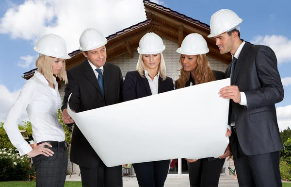 Group Of Architects Holding Blue Print — Stock Photo, Image