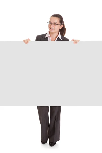 Businesswoman holding blank placard — Stock Photo, Image