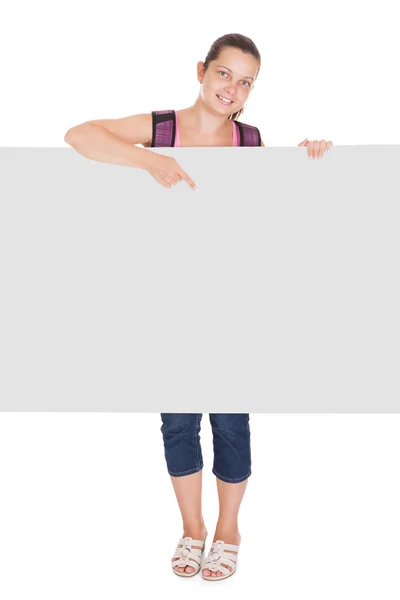 Female student pointing on placard — Stock Photo, Image