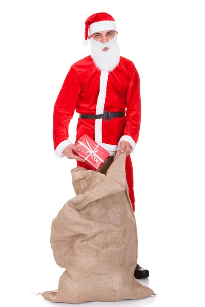 Santa Filling Bag With Gifts — Stock Photo, Image