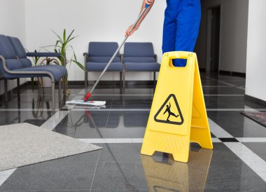 Man With Mop And Wet Floor Sign clipart