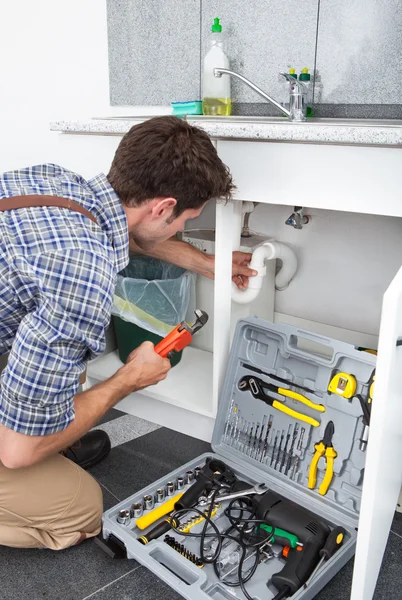 Plumber Fixing Sink In Kitchen — Stock Photo, Image