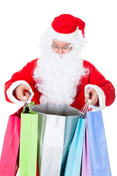 Papai Noel surpreso olhando dentro do saco de compras — Fotografia de Stock