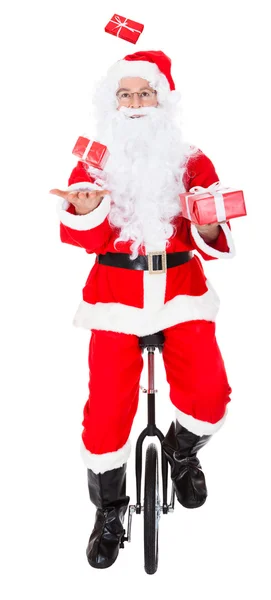 Santa juggling on monocycle — Stock Photo, Image