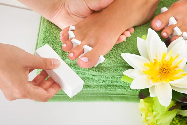 Manicure arquivando um unhas femininas — Fotografia de Stock