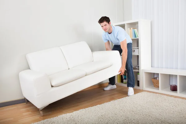 Man Lifting Couch — Stock Photo, Image