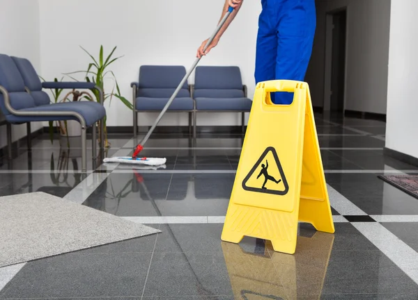 Man With Mop And Wet Floor Sign — Stock Photo, Image