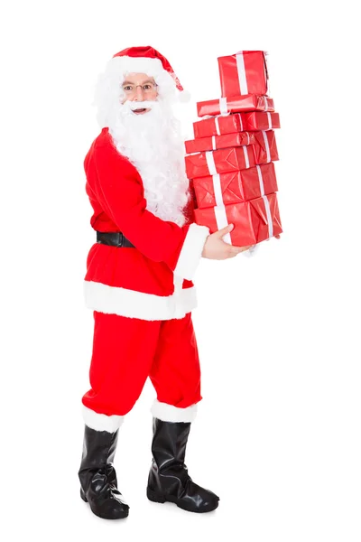Portrait of santa holding stack of gift Stock Picture
