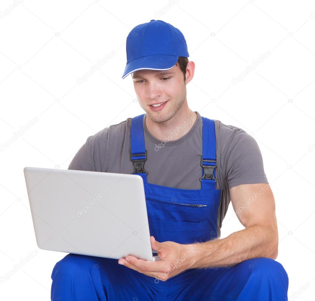 Mechanic Holding Laptop