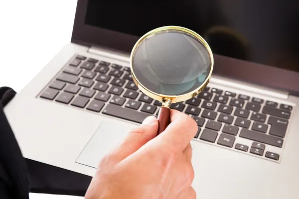 Man Holding Laptop And Magnifying Glass — Stok Foto