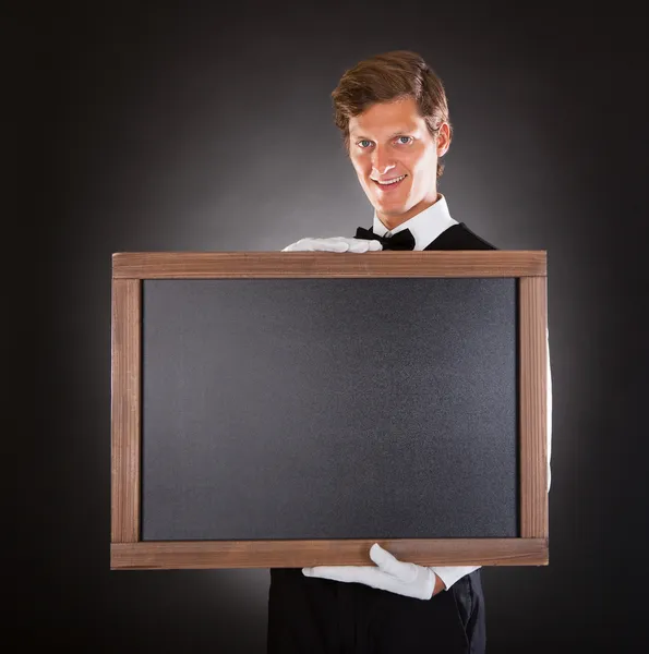 Male Waiter Holding Chalkboard — Stock Photo, Image