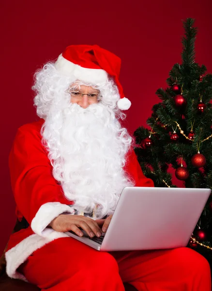 Weihnachtsmann mit Laptop — Stockfoto