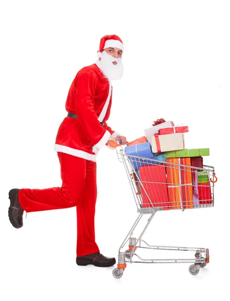 Santa sosteniendo carrito de compras —  Fotos de Stock