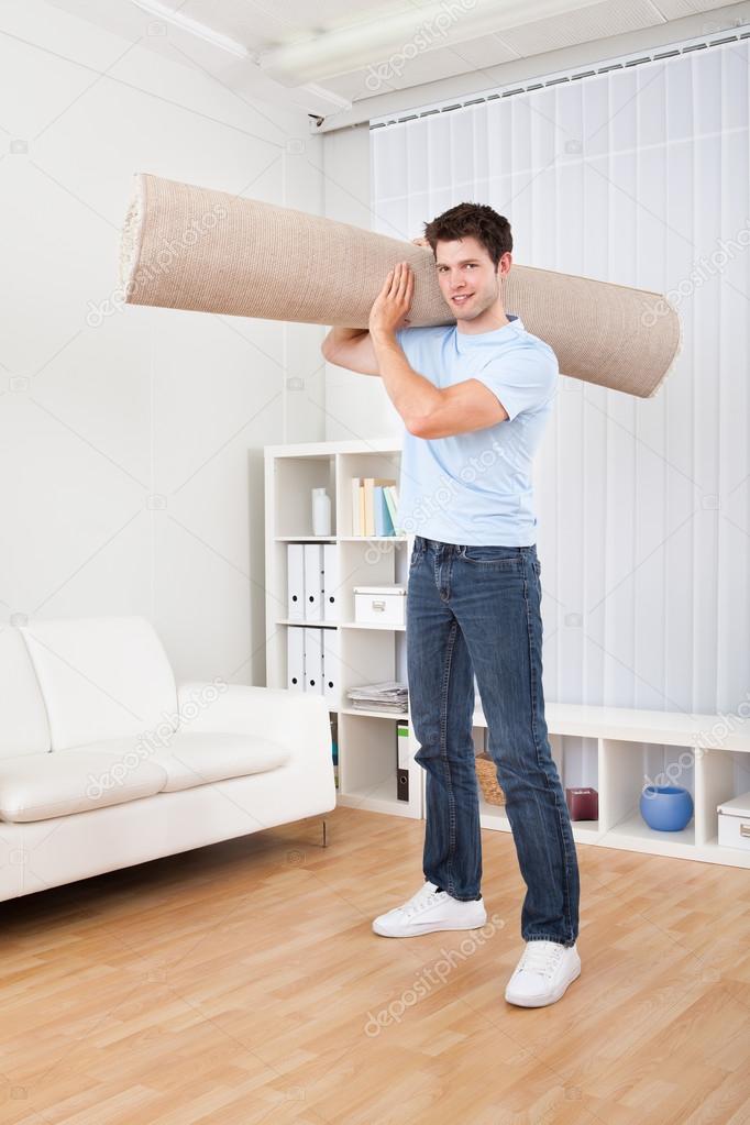 Young Man Holding Carpet