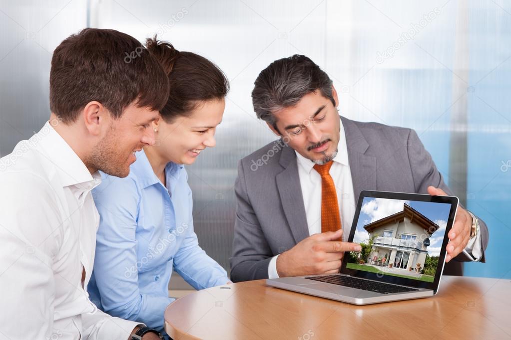 Couple And Consultant Discussing Together