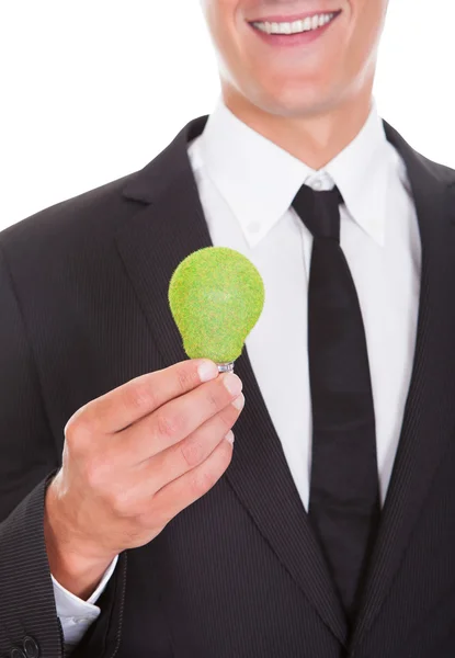 Businessman Holding Light Bulb With Green Grass — Stock Photo, Image