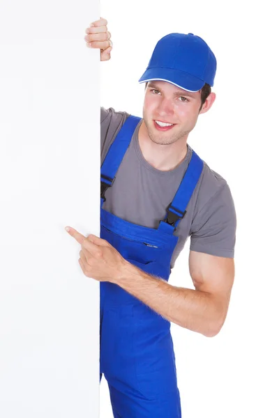 Hombre trabajador sosteniendo cartel en blanco — Foto de Stock