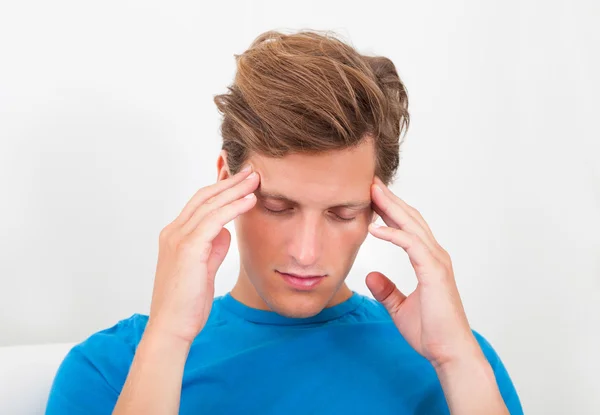 Young Man Holding His Temple While Suffering From Headache — Stock Photo, Image