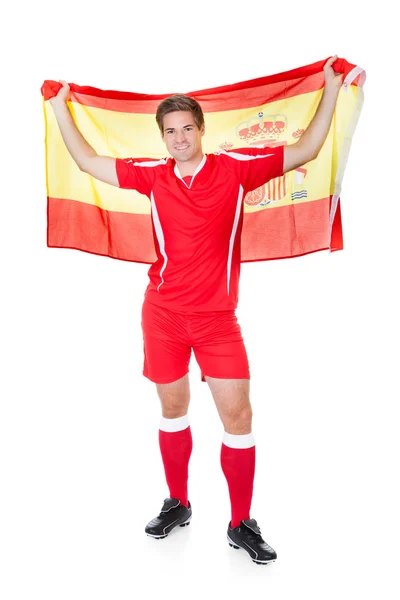 Jogador de futebol segurando bandeira espanhola — Fotografia de Stock