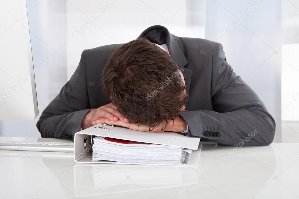 Tired Businessman Sleeping In Office
