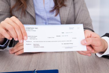 Businesspeople Holding Cheque clipart