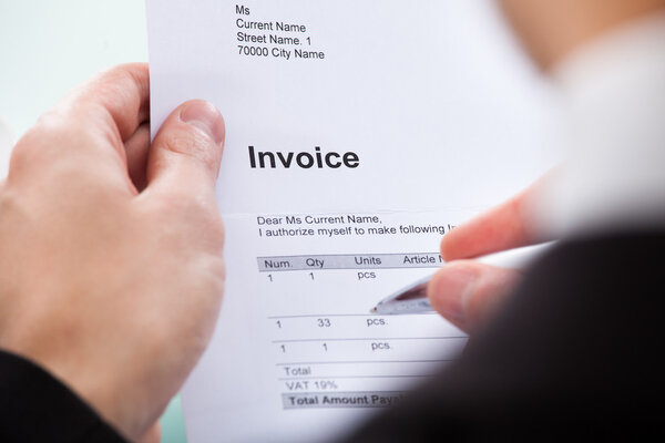 Businessman Holding Invoice