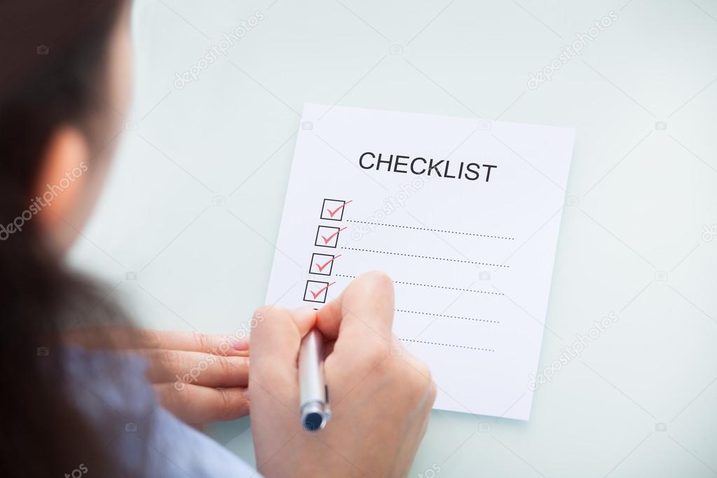 Businesswoman Marking On Checklist