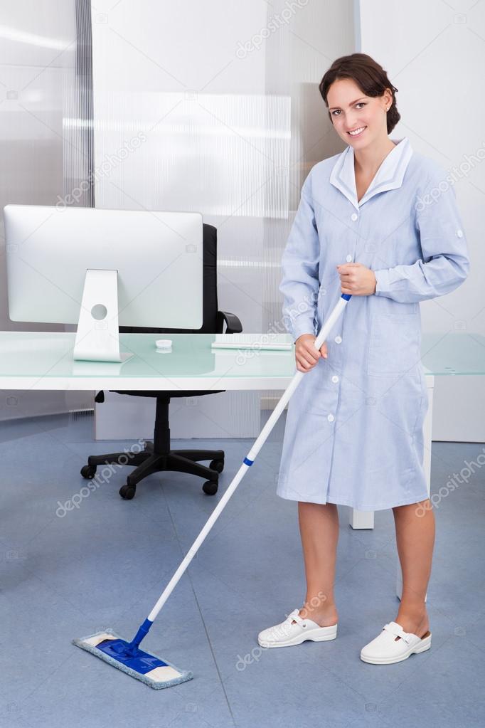 Maid Cleaning Floor In Office