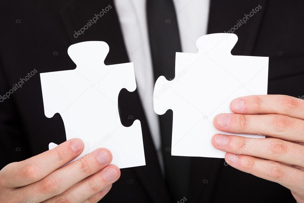 Businessman Solving Jigsaw Puzzle