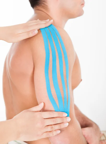 Person Applying Special Kinesio Tape On Man's Shoulder — Stock Photo, Image