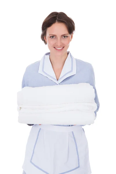 Maid Holding Stack Of Towels — Stock Photo, Image