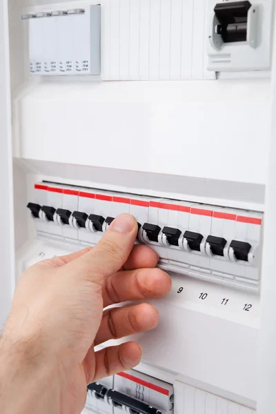 Human Hand On Distribution Board — Stock Photo, Image