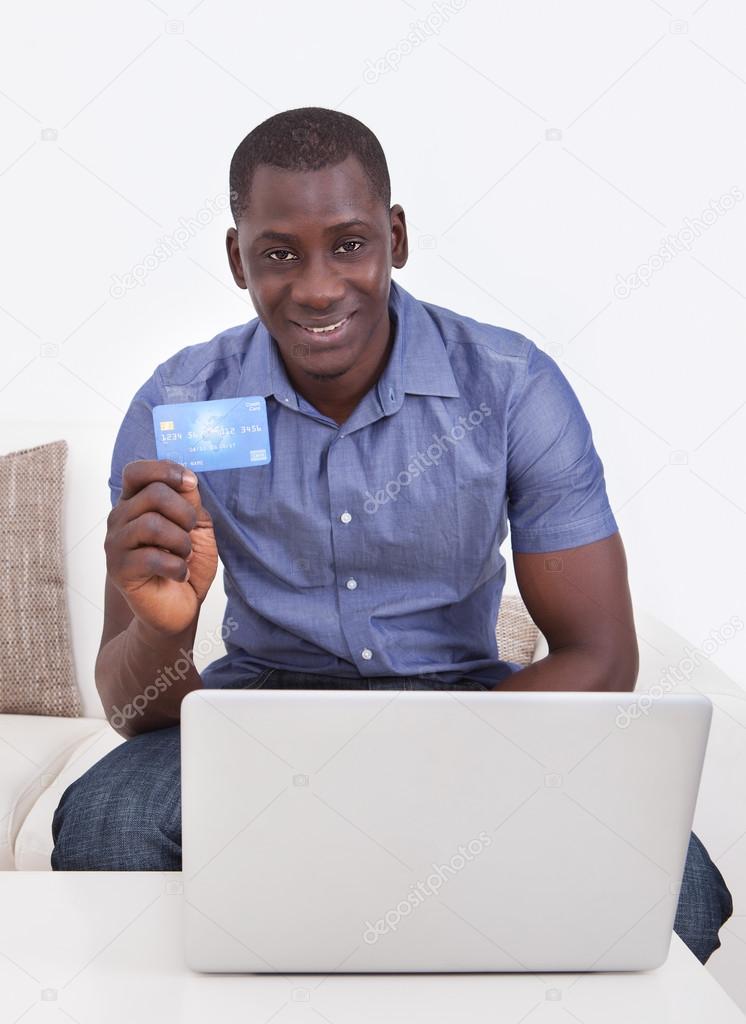 African Man With Credit Card And Laptop
