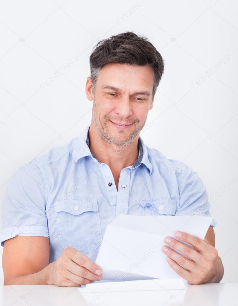 Mature Man Reading Letter