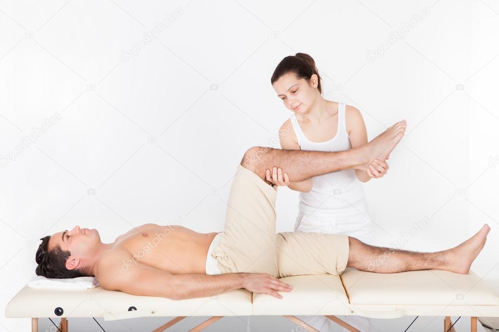 Woman Massaging Man's Foot