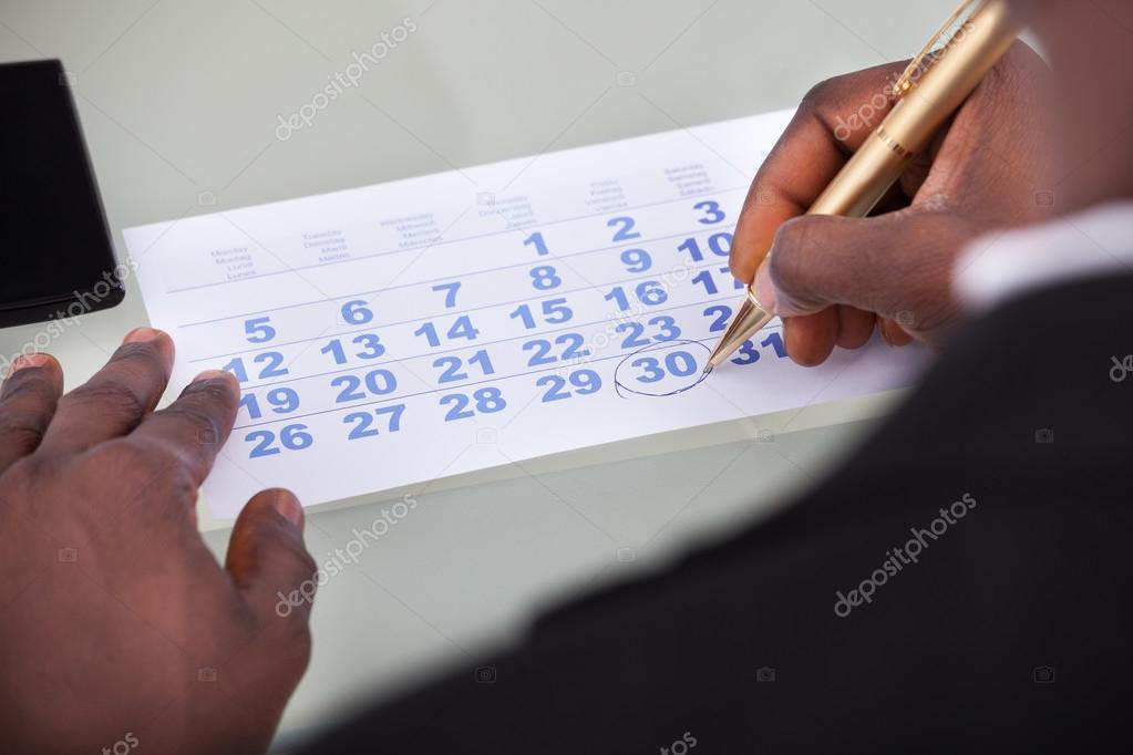 Businessman Marking On Calendar