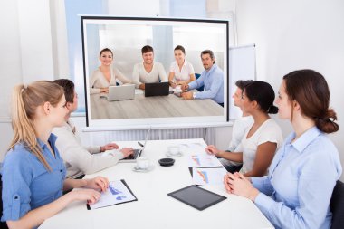 Businesspeople Attending Video Conference clipart